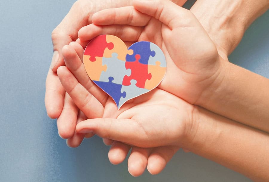 Hands holding a heart together